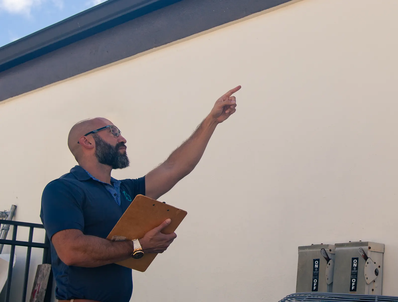 Joe Ford, owner of Dolphin Claims, pointing out exterior damage during an inspection